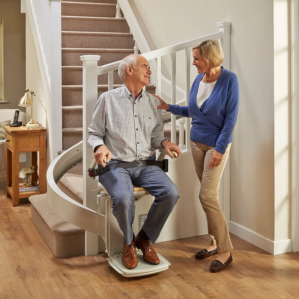 Man and woman curved stairlift
