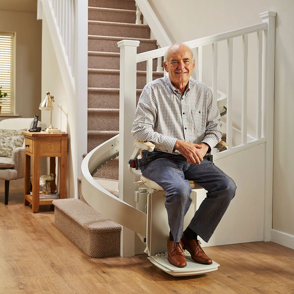 Man sitting on Curved Acorn Stairlift